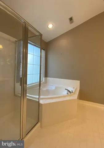 a view of a room with a ceiling fan