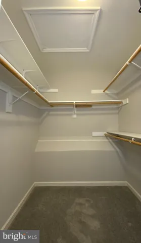 a view of a hallway with wooden floor and entryway