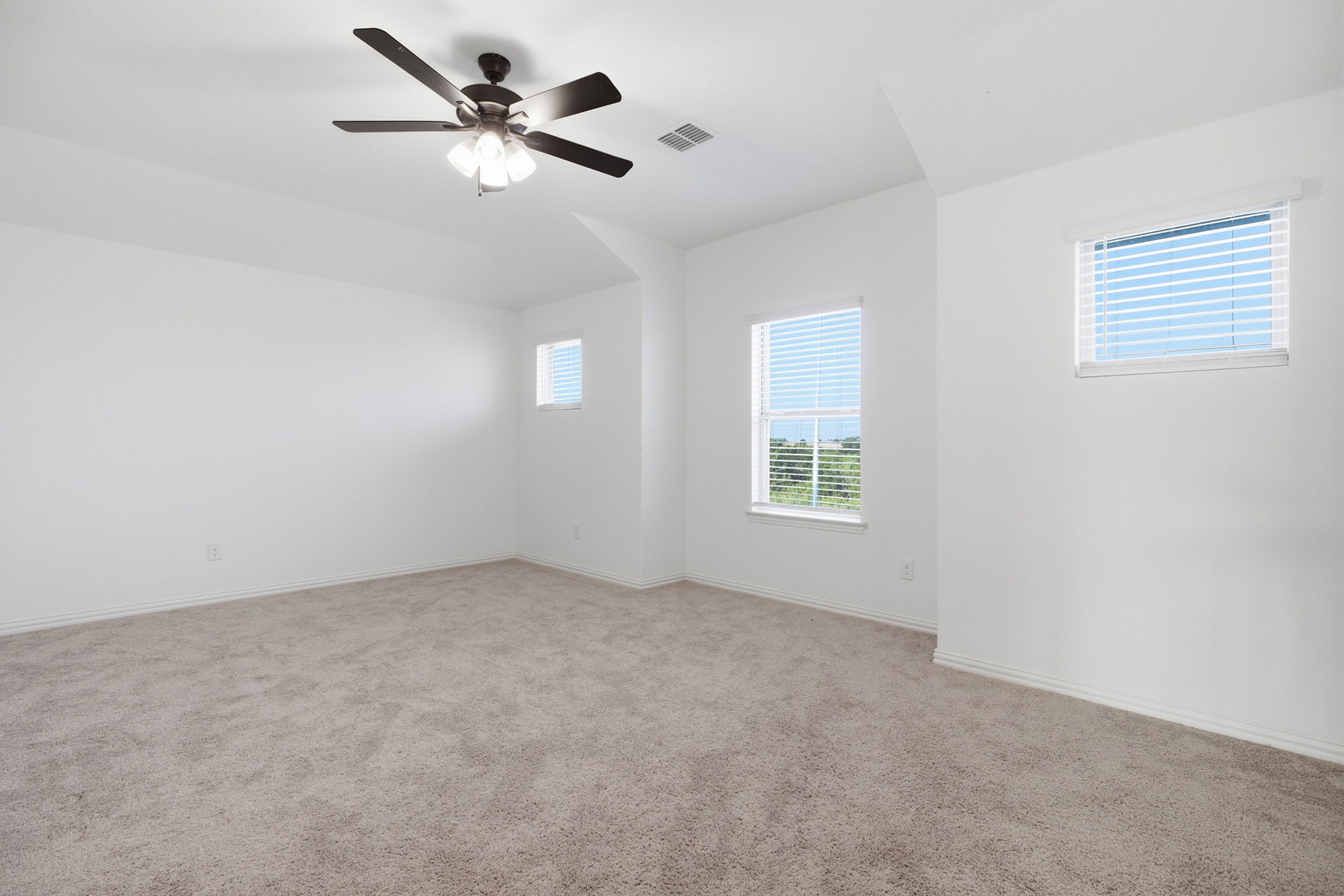 13720 Jon Ryan Road Manor, TX 78653 - Photo 23 of 31 A spacious, naturally illuminated room features plush carpeting and a modern ceiling fan for ultimate comfort.