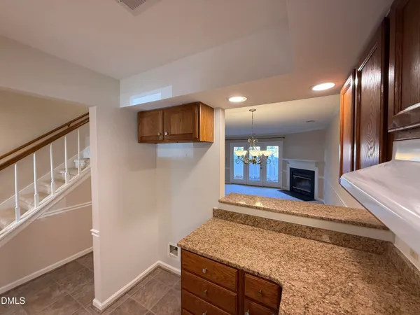 a kitchen with granite countertop a sink stove and cabinets