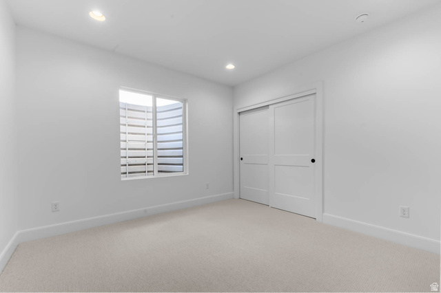 11711 South Halls Crk Road Draper, UT 84020 - Photo 25 of 31 Unfurnished bedroom featuring light carpet, a closet, and recessed lighting
