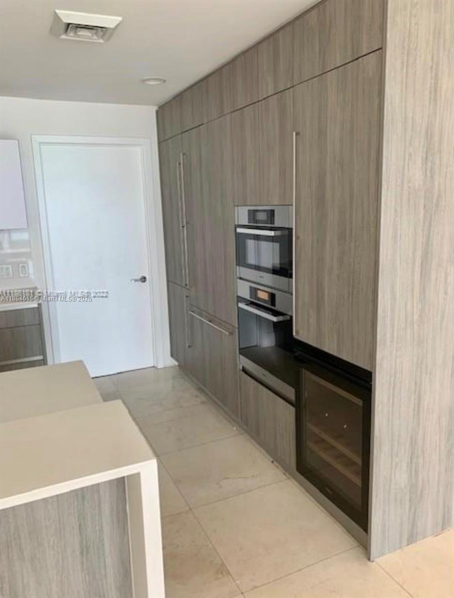 Key Biscayne Key Biscayne, FL 33149 - Photo 6 of 17 a kitchen with granite countertop a refrigerator and a sink