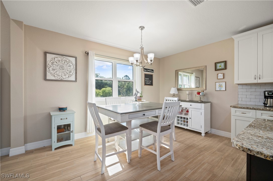 1606 Navigator Road Punta Gorda, FL 33983 - Photo 11 of 47 a view of a dining room with furniture window and wooden floor