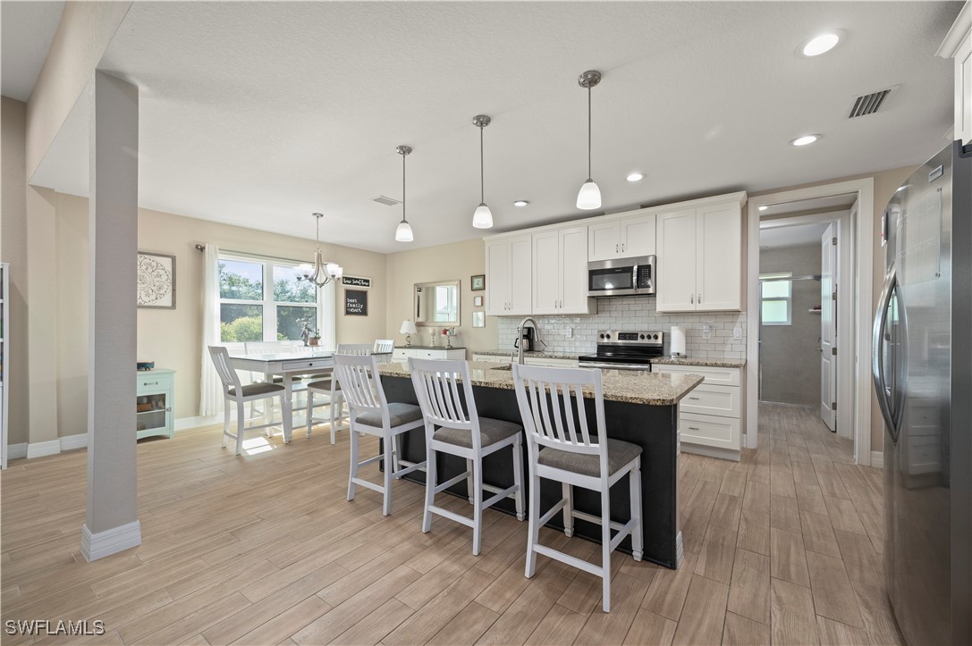 1606 Navigator Road Punta Gorda, FL 33983 - Photo 12 of 47 a view of a dining room with furniture a rug and wooden floor