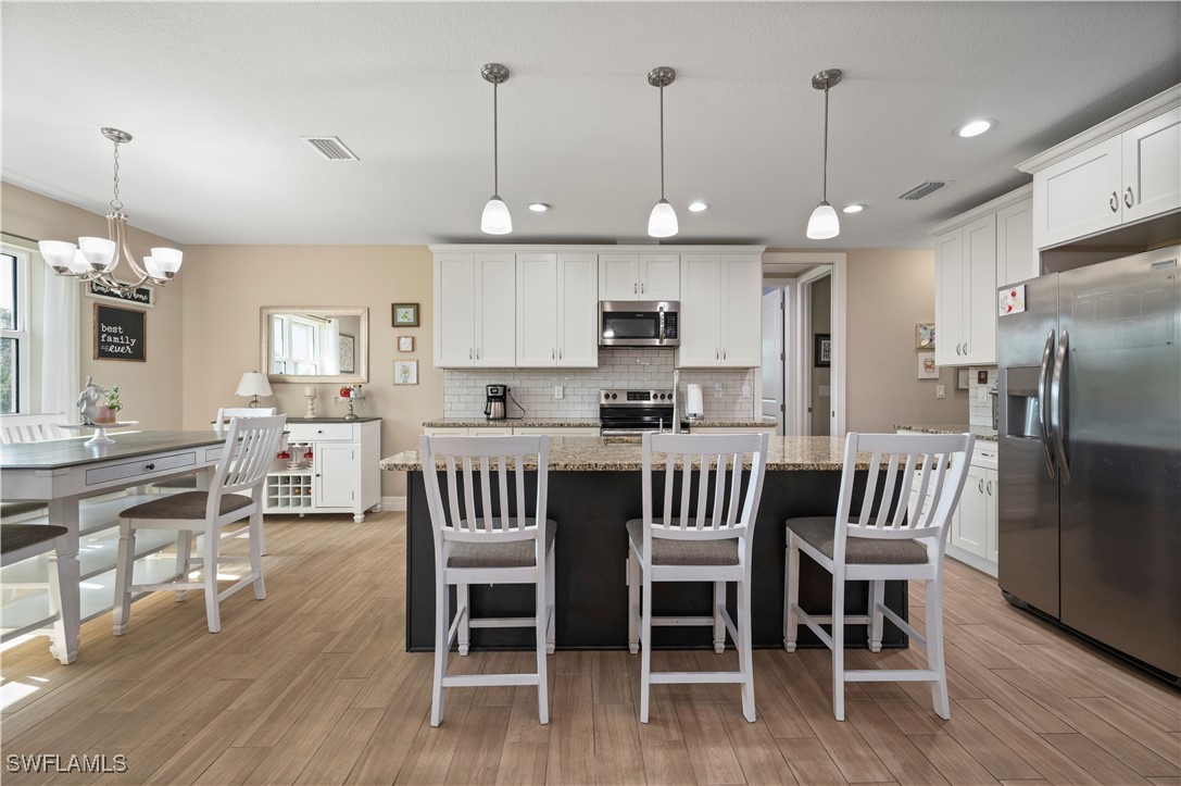 1606 Navigator Road Punta Gorda, FL 33983 - Photo 13 of 47 a view of kitchen with cabinets table and chairs