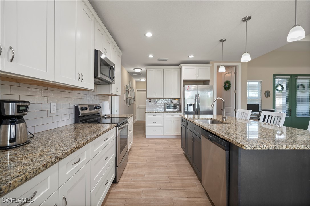 1606 Navigator Road Punta Gorda, FL 33983 - Photo 14 of 47 a large kitchen with granite countertop lots of counter space sink and appliances