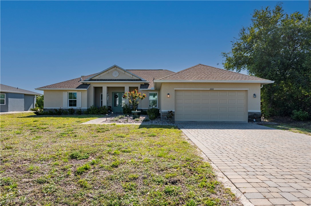 1606 Navigator Road Punta Gorda, FL 33983 - Photo 2 of 47 a front view of a house with a yard