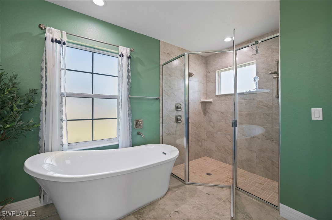 1606 Navigator Road Punta Gorda, FL 33983 - Photo 22 of 47 a white bath tub sitting next to a shower