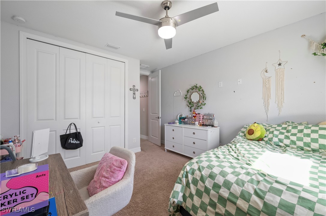 1606 Navigator Road Punta Gorda, FL 33983 - Photo 27 of 47 a bedroom with a bed and a chandelier