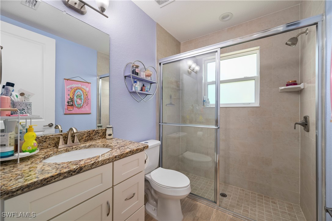 1606 Navigator Road Punta Gorda, FL 33983 - Photo 28 of 47 a bathroom with a granite countertop sink toilet and shower
