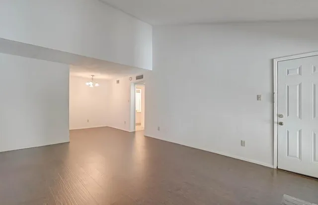 a view of an empty room and wooden floor