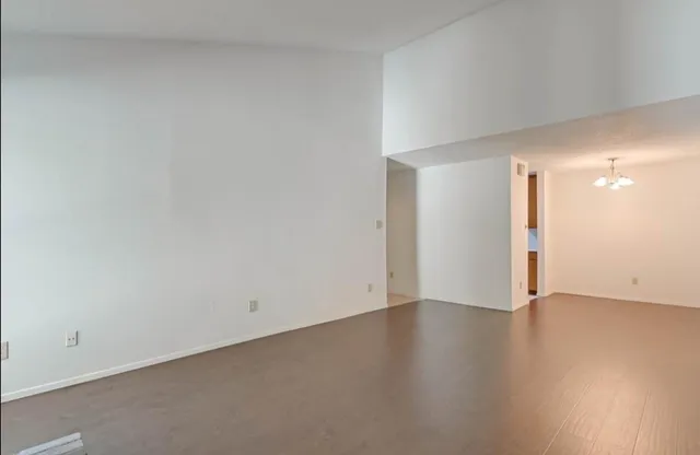 a view of an empty room and wooden floor