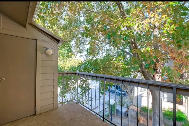 a view of a balcony with a tree