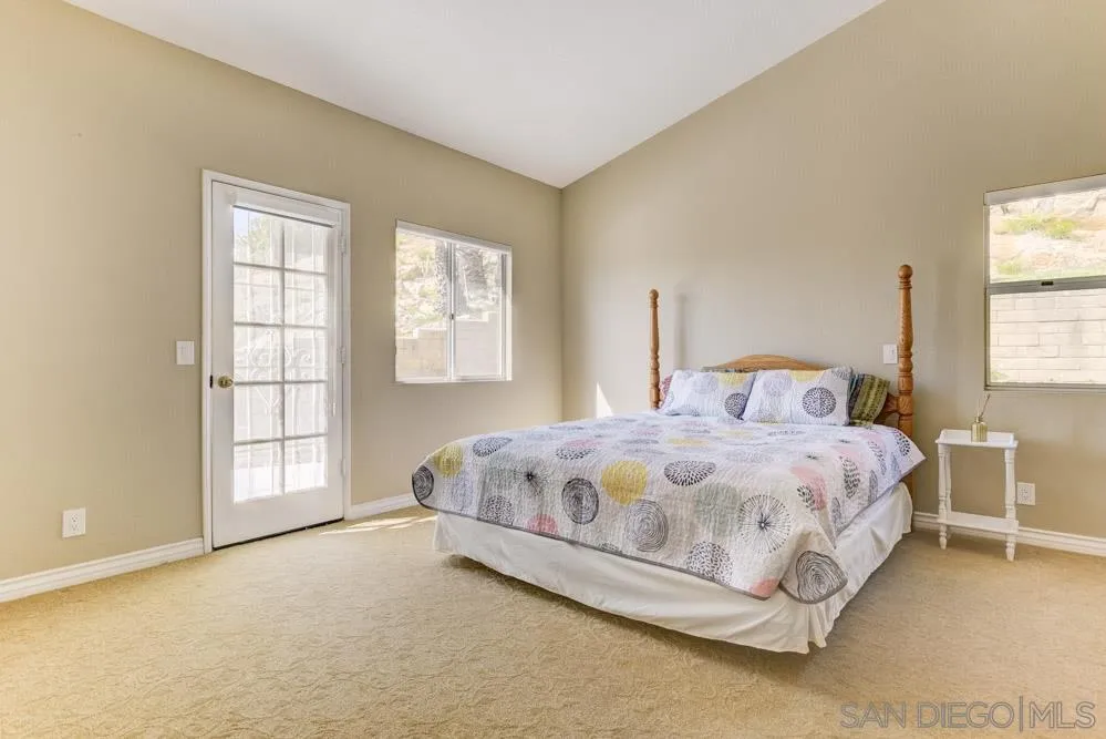2762 Jody Place Escondido, CA 92027 - Photo 15 of 25 a large bed sitting in a bedroom next to a window