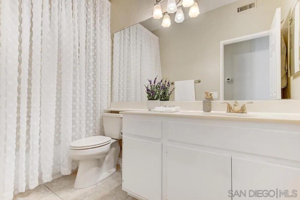 2762 Jody Place Escondido, CA 92027 - Photo 17 of 25 a bathroom with a sink a toilet and a mirror