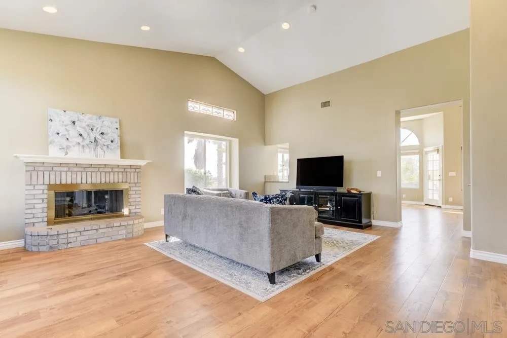 2762 Jody Place Escondido, CA 92027 - Photo 5 of 25 a living room with furniture a flat screen tv and a fireplace