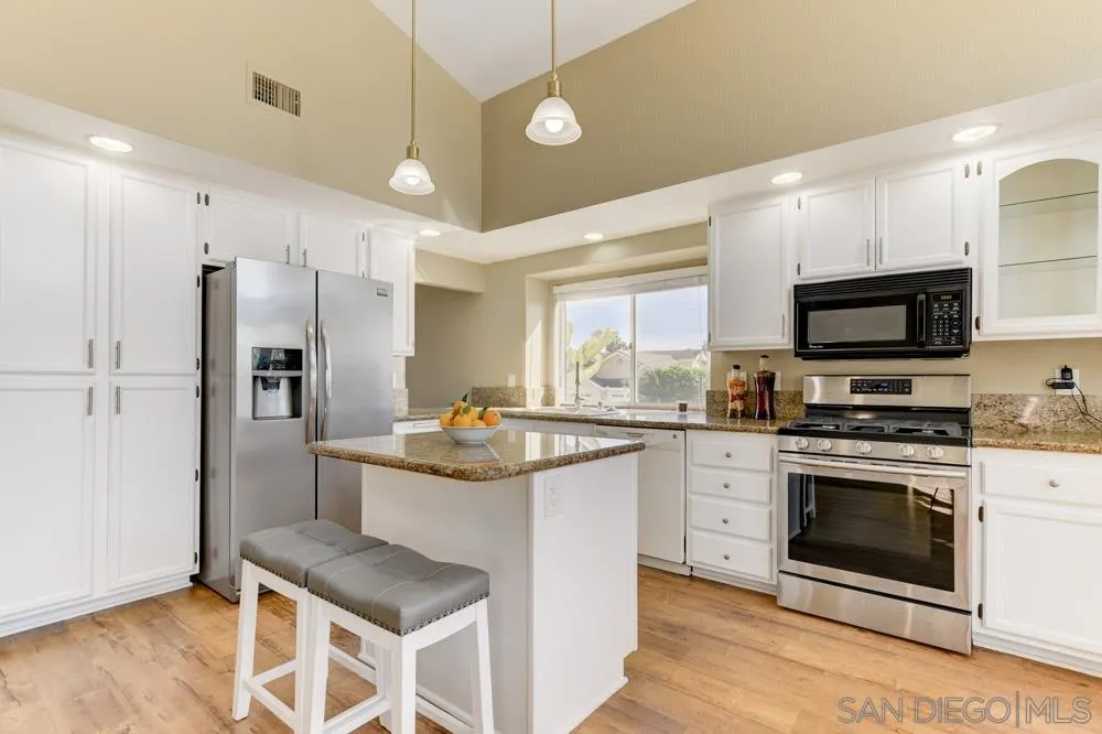 2762 Jody Place Escondido, CA 92027 - Photo 7 of 25 a kitchen with stainless steel appliances granite countertop a stove a sink and a refrigerator