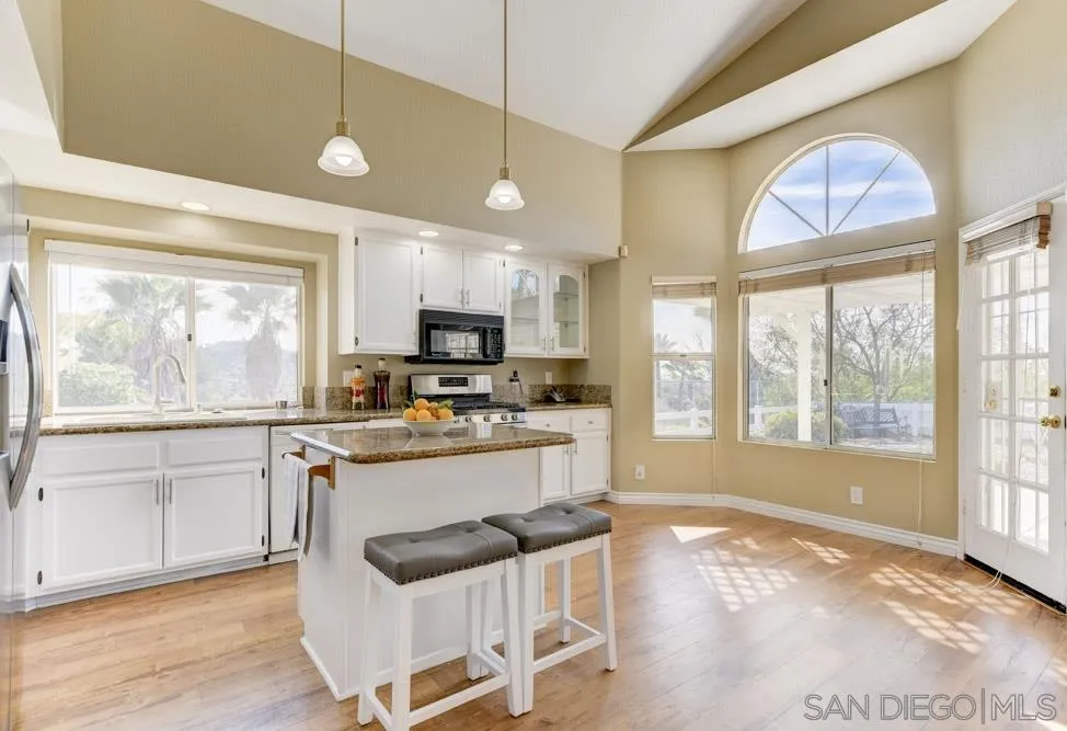 2762 Jody Place Escondido, CA 92027 - Photo 9 of 25 a kitchen with stainless steel appliances granite countertop a stove and cabinets