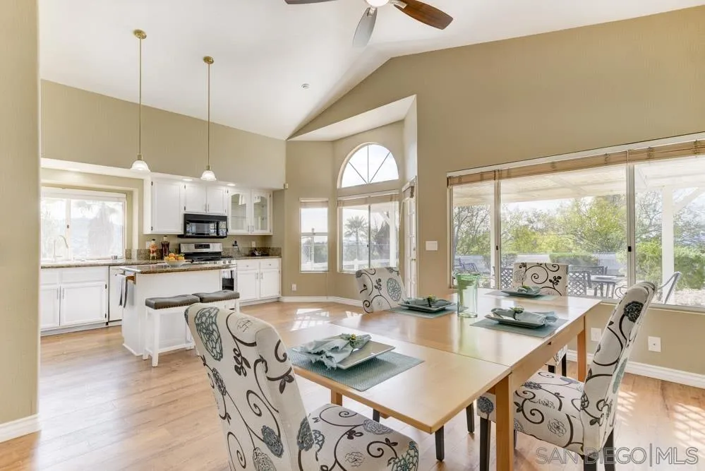 2762 Jody Place Escondido, CA 92027 - Photo 10 of 25 a large kitchen with a table chairs and flat screen tv