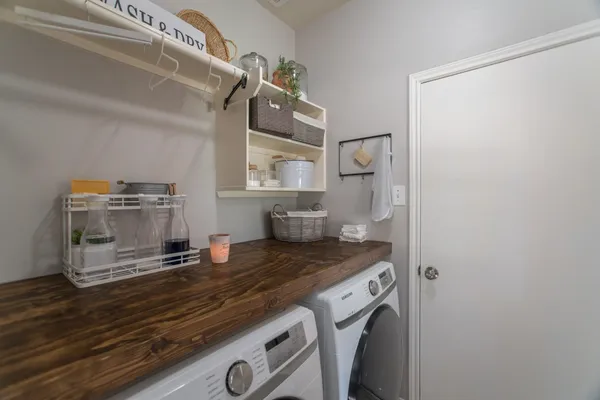 a view of a storage and utility room with washer and dryer