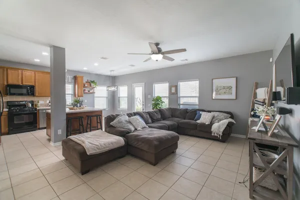 a living room with furniture and kitchen view