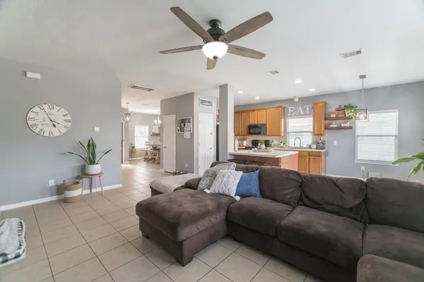 a living room with furniture and kitchen view