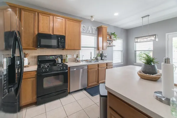 a kitchen with a sink stove and microwave
