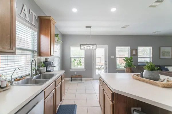 a kitchen with a sink and living room