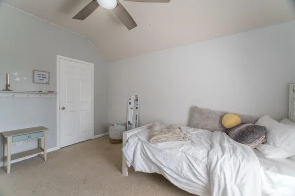 a bedroom with a bed and a ceiling fan