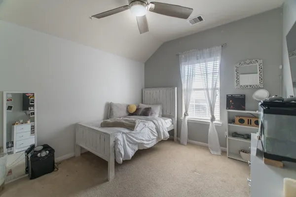 a bed room with a bed and a chair