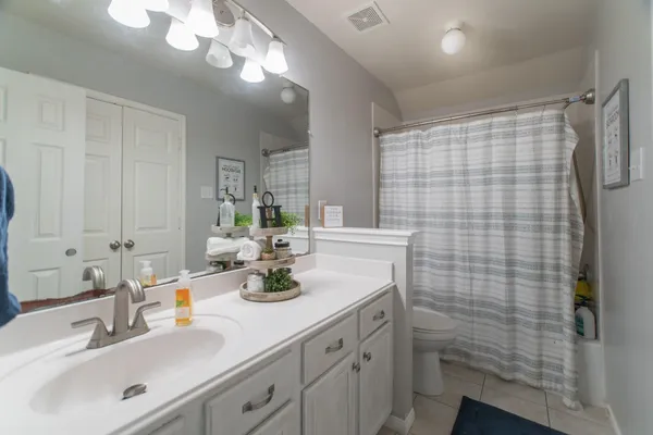 a bathroom with a sink a vanity and shower