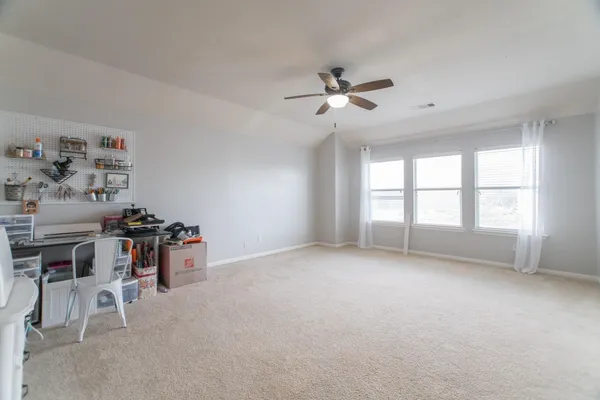 a view of a livingroom with furniture and a ceiling fan
