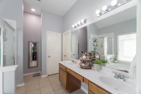 a bathroom with a sink double vanity and a mirror