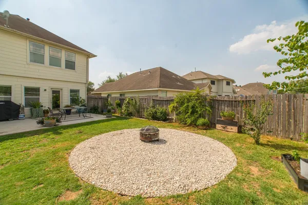 a view of a house with swimming pool and sitting area