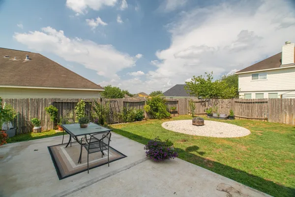 a swimming pool with outdoor seating and green space