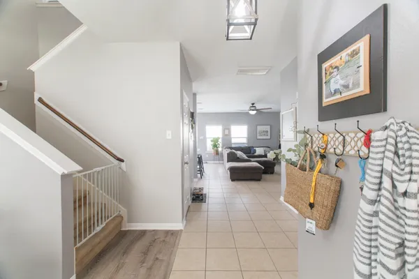 a view of a livingroom with furniture and stairs
