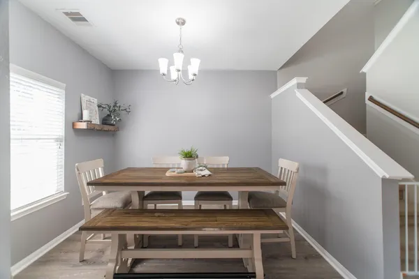 a view of a dining room with furniture and a window