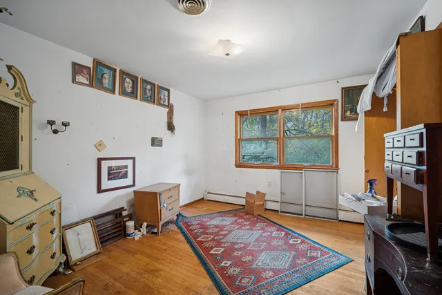 a living room with furniture flat screen tv and a window
