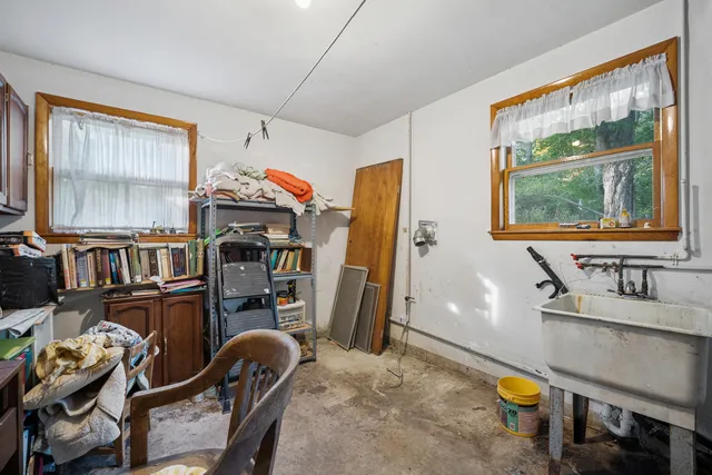 a living room with furniture a flat screen tv and a window