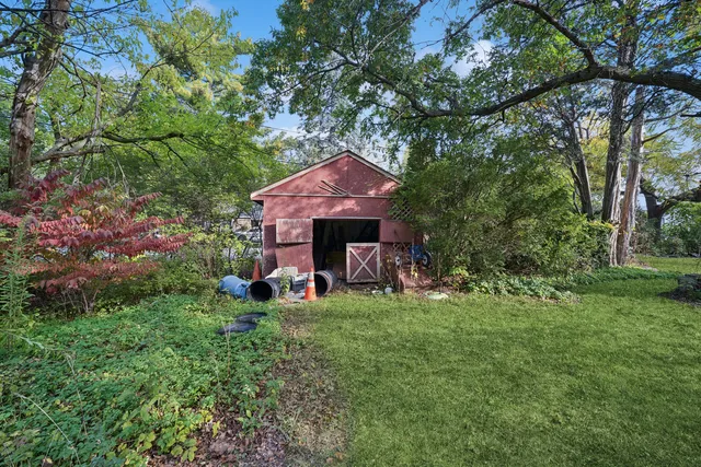 a view of a house with a yard and sitting area