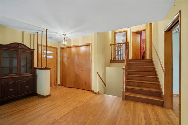a view of a kitchen with furniture and wooden floor