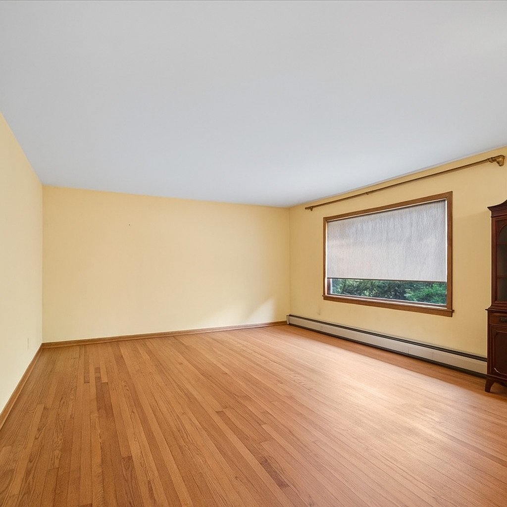 1068 North Hainesville Road Round Lake, IL 60073 - Photo 6 of 31 a view of an empty room with wooden floor and a window