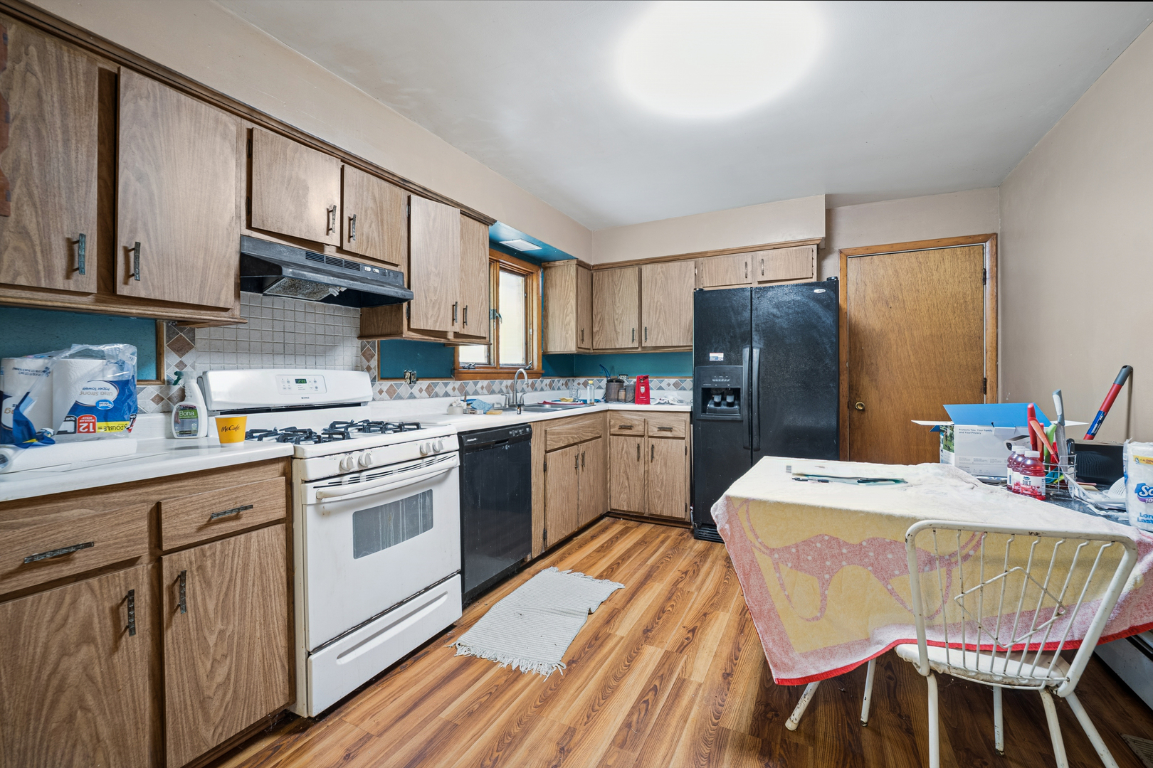 1068 North Hainesville Road Round Lake, IL 60073 - Photo 7 of 31 a kitchen with a sink a stove a refrigerator and cabinetry
