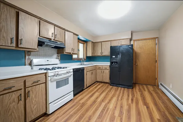 a kitchen with stainless steel appliances granite countertop a stove a sink dishwasher and a refrigerator
