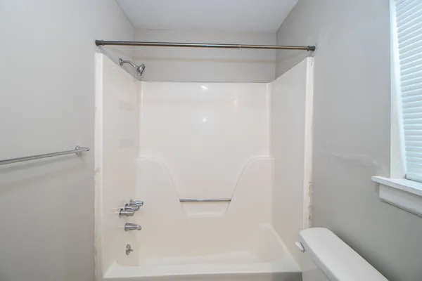 a bathroom with a shower and a bathtub