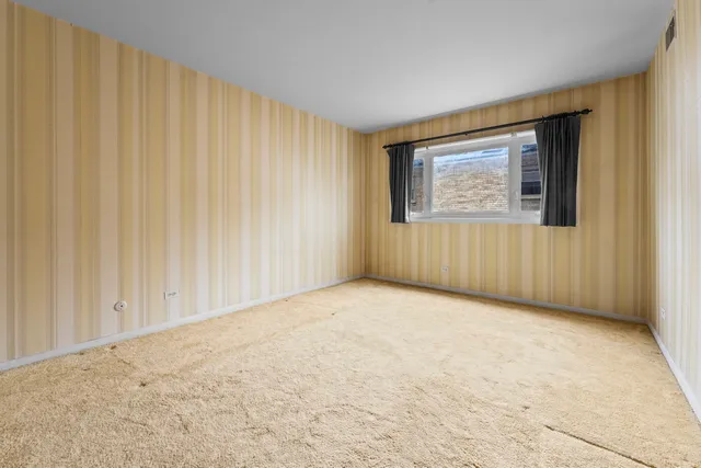 an empty room with a wooden door