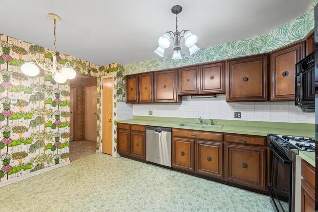 a kitchen with stainless steel appliances granite countertop a sink and a stove