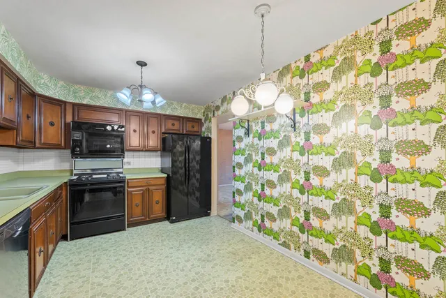 a kitchen with stainless steel appliances granite countertop a stove refrigerator sink and cabinets