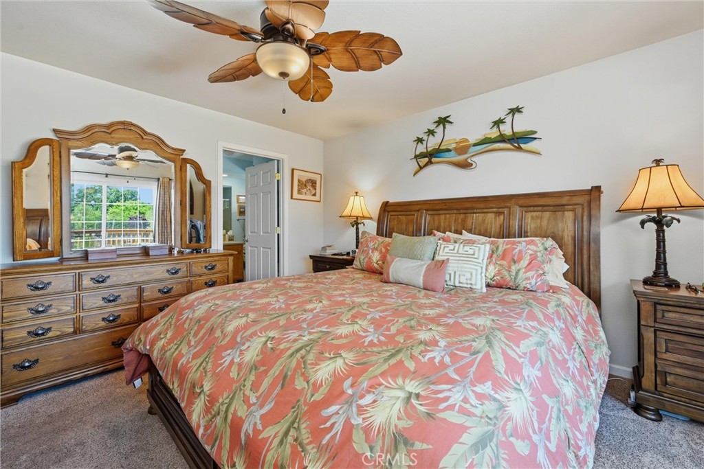 18650 Horseshoe Road Hidden Valley Lake, CA 95467 - Photo 17 of 26 a bedroom with a bed and a chandelier