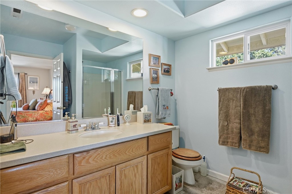 18650 Horseshoe Road Hidden Valley Lake, CA 95467 - Photo 18 of 26 a bathroom with a toilet sink and mirror